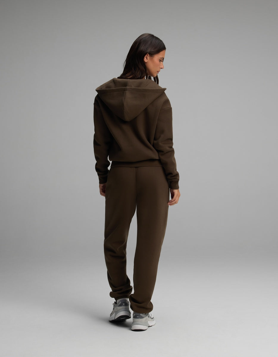A woman seen from the back wearing a dark brown Women’s Cityscape Full-Zip Hoodie & Sweatpant Set.