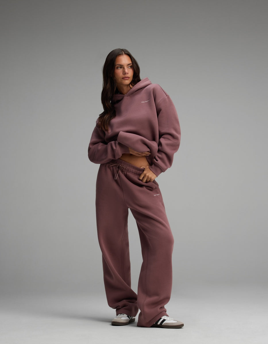 A person wearing a dusty plum-colored Women’s Cityscape Hoodie & Wide Leg Pant Set, standing against a neutral background.