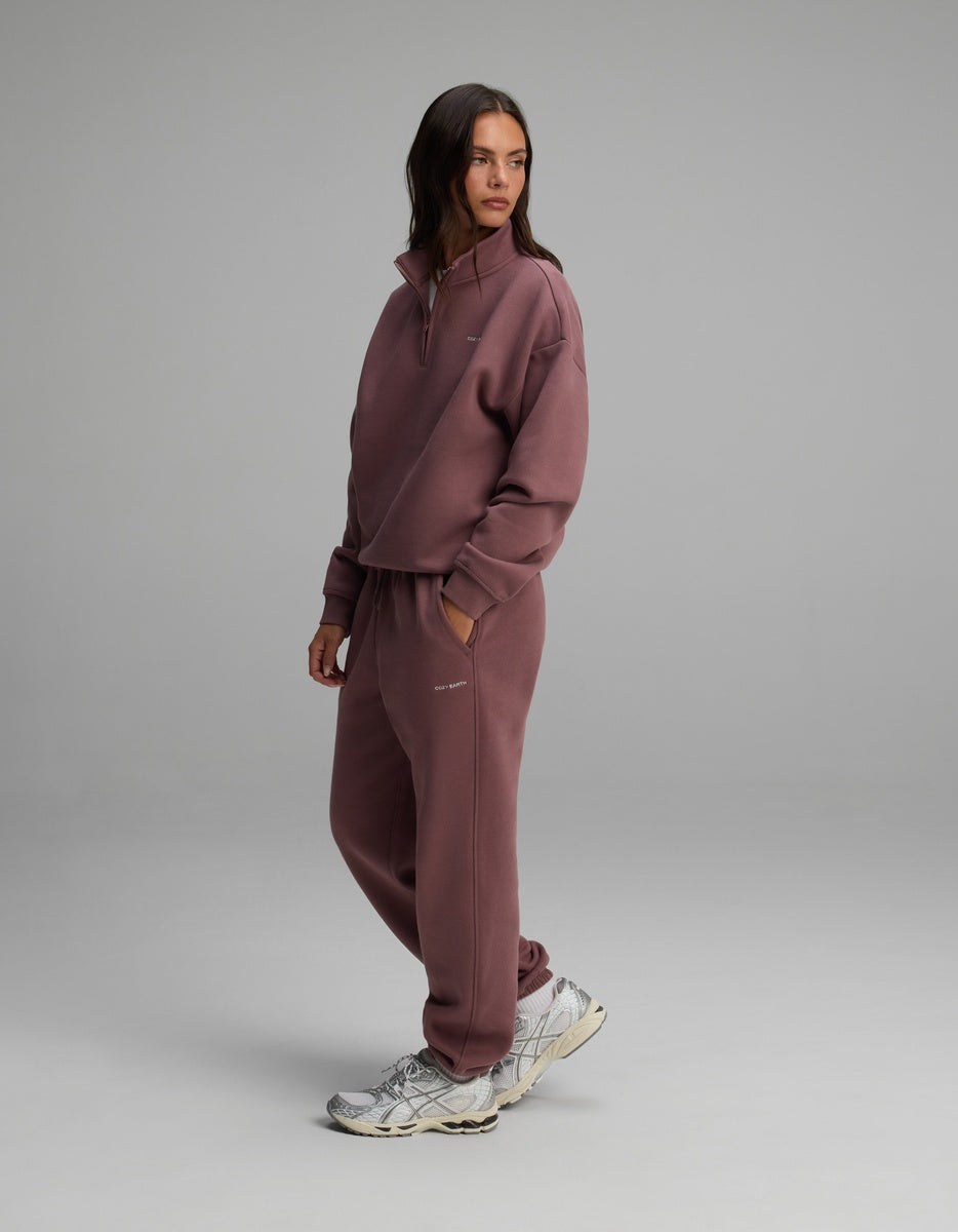 A woman wearing a mauve Women’s Cityscape Quarter Zip & Sweatpant Set.