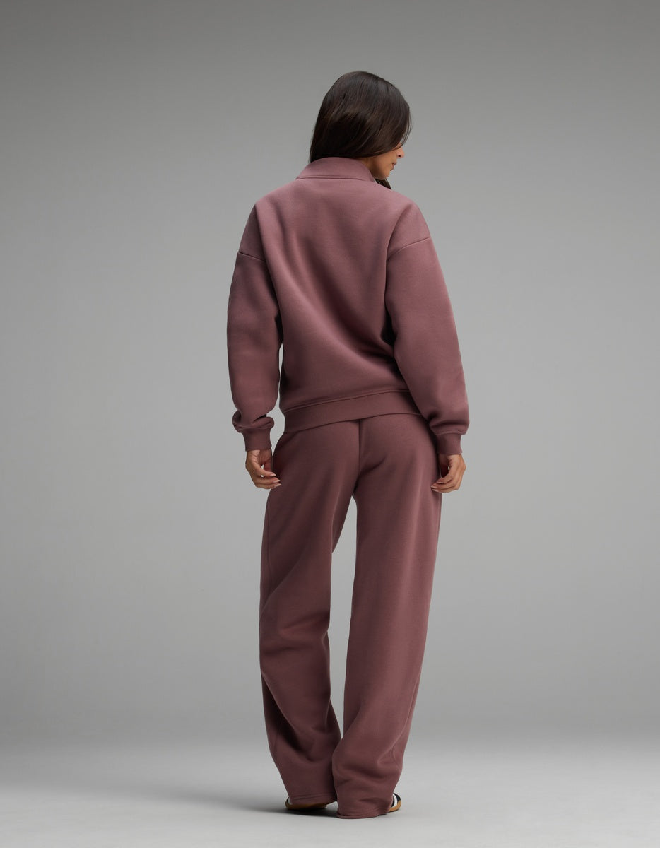A person seen from behind wearing a mauve Women’s Cityscape Quarter Zip & Wide Leg Pant Set consisting of a quarter-zip sweatshirt and matching wide-leg lounge pants.