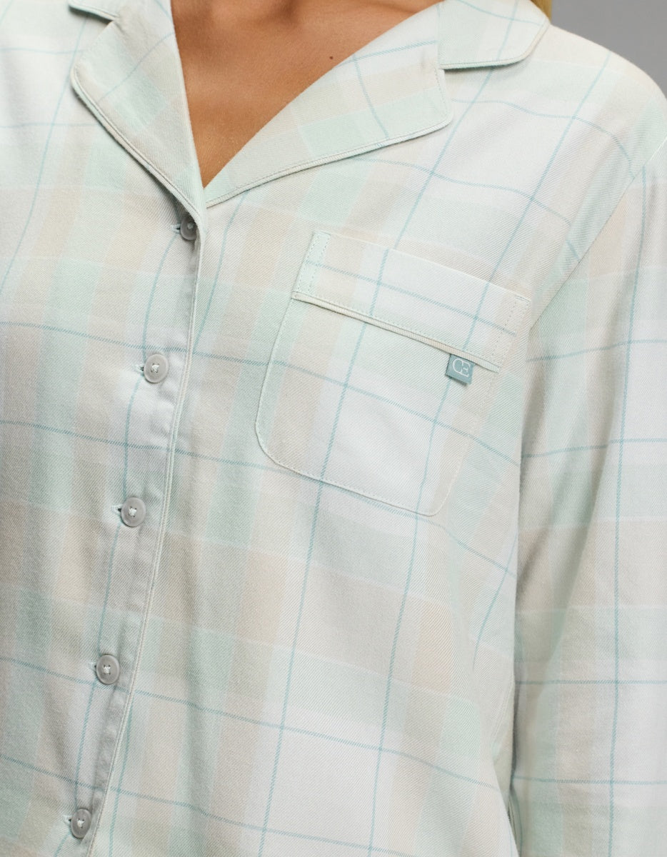Close-up of a Women’s Farmhouse Long Sleeve Pajama Top in a pale green and white plaid pattern with a chest pocket.