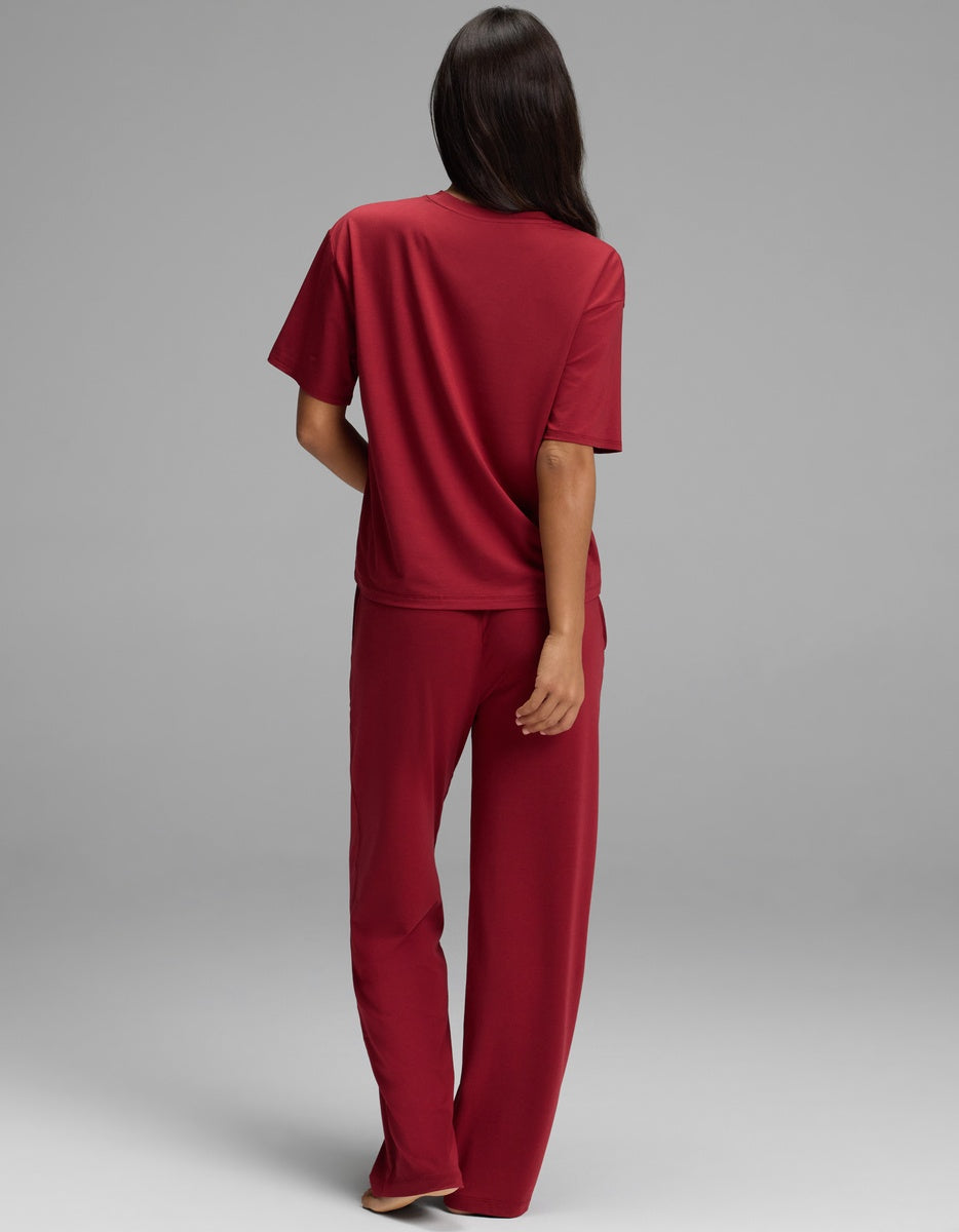 A person seen from the back wearing a burgundy Women’s First Layer Pajama Short Sleeve Tee & Pajama Pant Set.