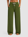 A woman stands barefoot with hands in pockets, wearing Cozy Earth's Women's Studio Wide Leg Pant in olive green, featuring an elastic waistband and white drawstring, against a simple background.|Color:Grove