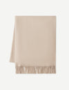 The Cozy Earth Cashmere Tassel Throw, shown neatly folded with a tasseled edge, is displayed on a white background.