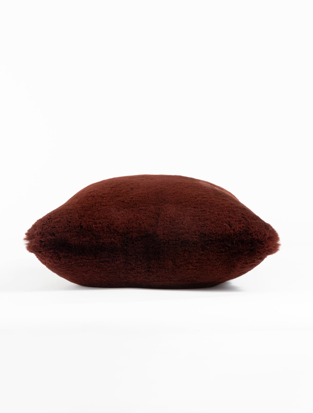 The Cozy Earth Cuddle Pillow - Last Chance is a plush, rectangular maroon pillow with a soft, furry texture, displayed against a plain white background.