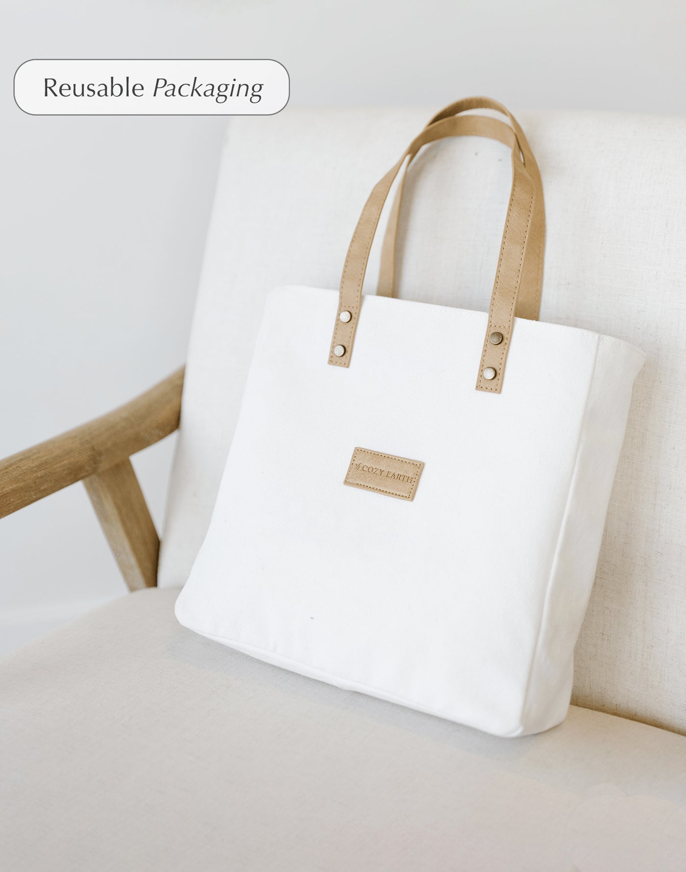 Duvet cover bag sitting on a chair. Comes with duvet covers in White, Oat, Driftwood, Charcoal, Light Grey, Olive, Navy, Sage, Harbor Mist, Clay, Walnut, Pacific Blue, Stone, Creme, Shore, and Dove Grey, Peony