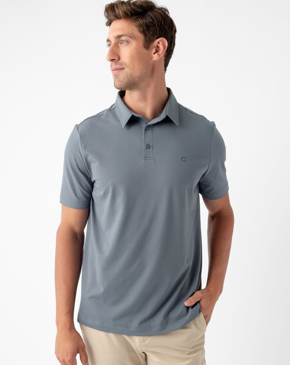 Man wearing a blue Cozy Earth Everyday Polo shirt stands in front of white background