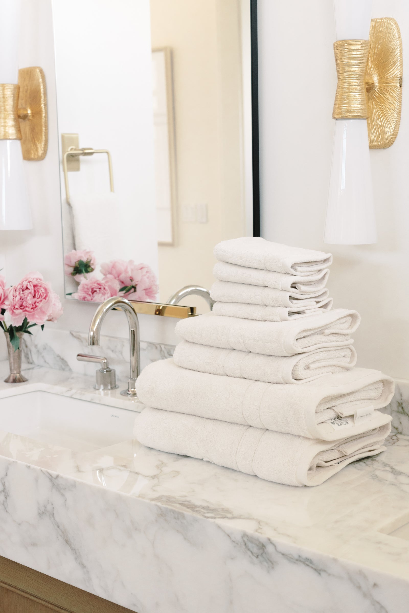 Premium Plush Bath Towel Set in the color Seashell. Photo of Clay Premium Plush Bath Towel Set taken in a bathroom featuring white backsplash tile 