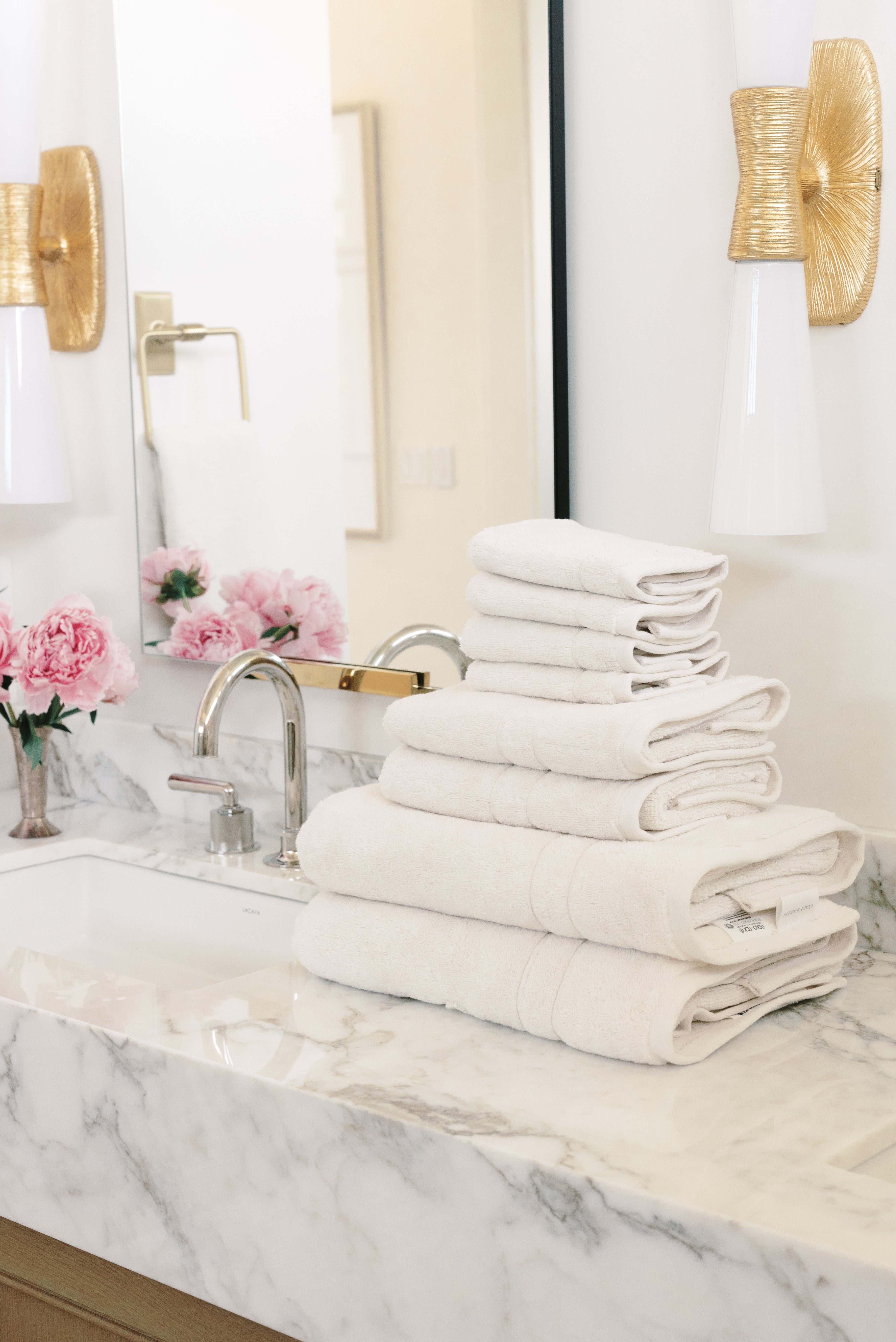 Premium Plush Bath Towel Set in the color Seashell. Photo of Clay Premium Plush Bath Towel Set taken in a bathroom featuring white backsplash tile |Color:Seashell