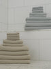 Video of Harbor Mist and Sand Waffle Bath Towels resting on marble counter tops.