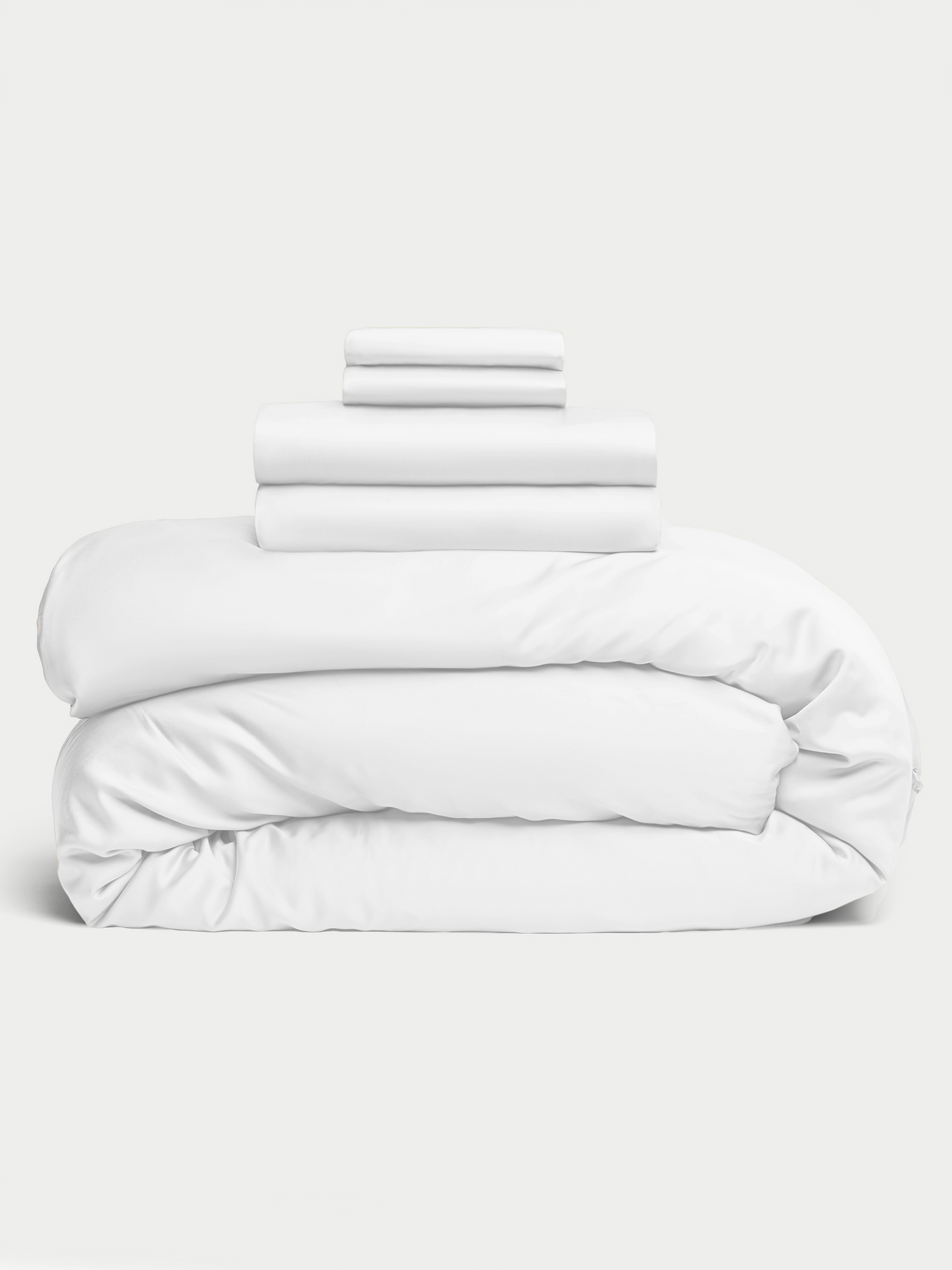 White bedding bundle stacked up with white background 