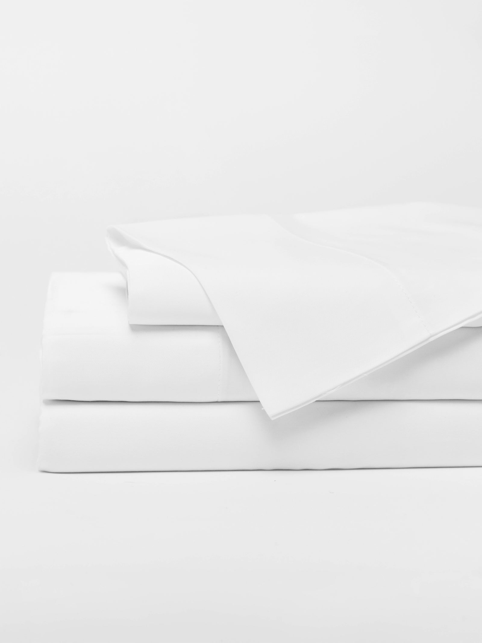 White sheet set folded with a white background 