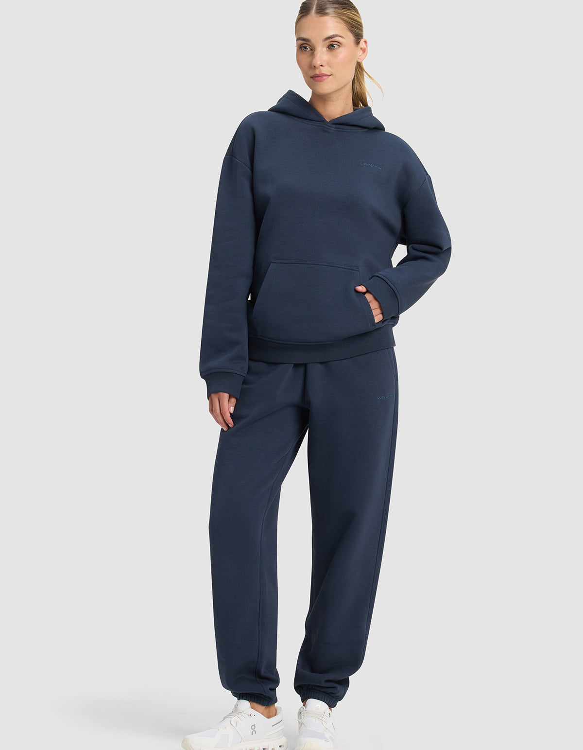 A woman wears Cozy Earth Cityscape 2.0 Hoodie & Sweatpant set in dark blue