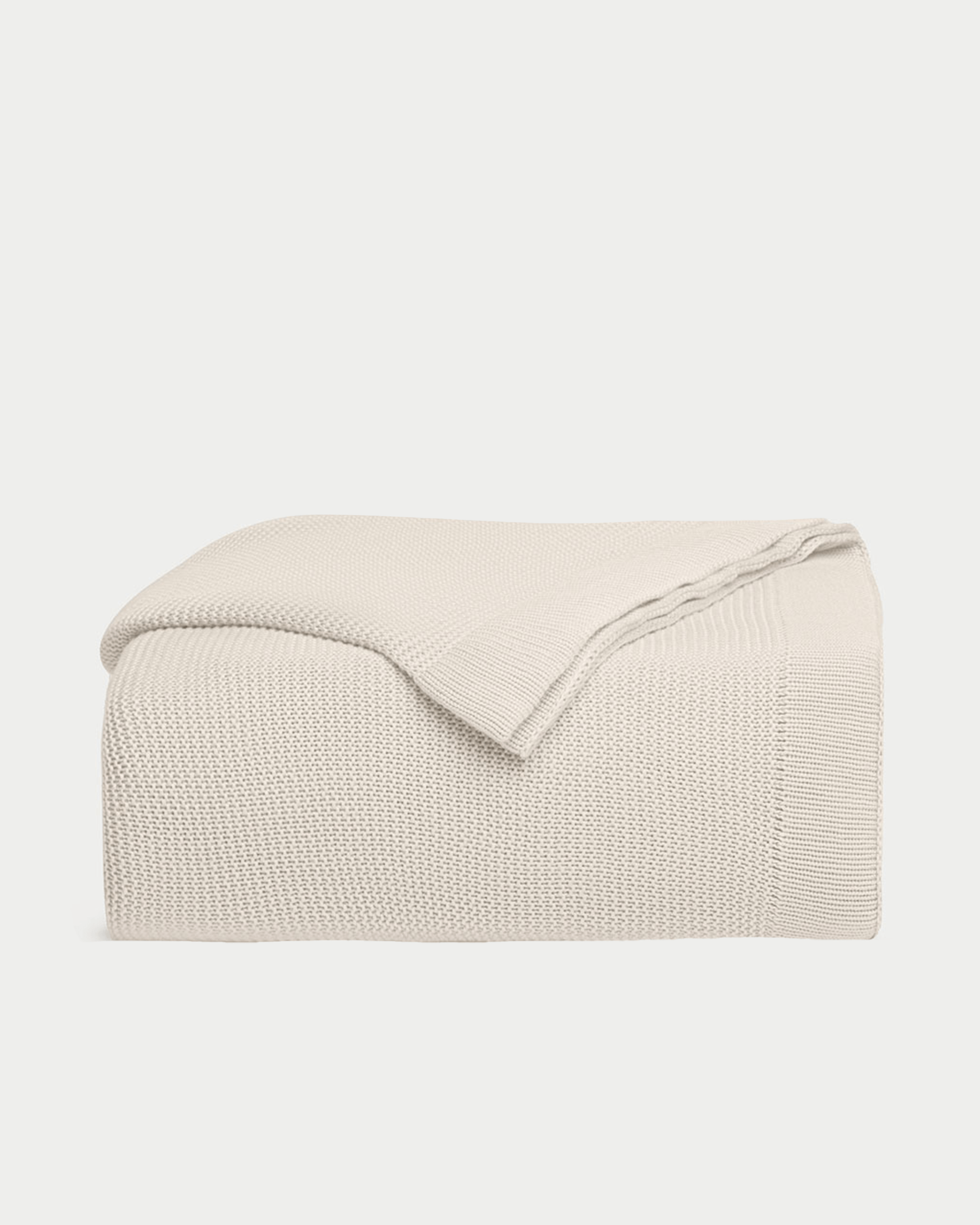 Driftwood cloud knit blanket folded with white background 