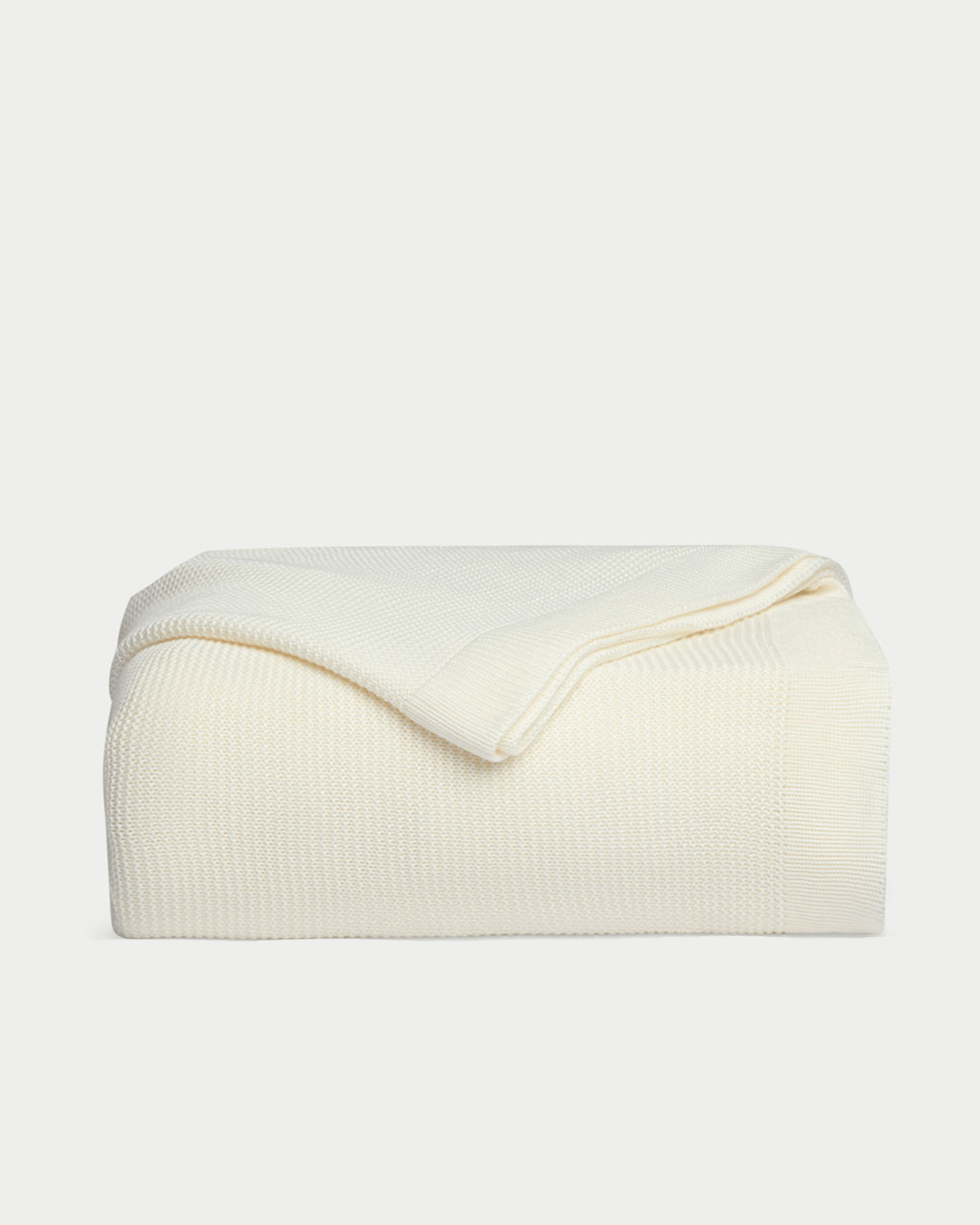 Ivory cloud knit blanket folded with white background |Color:Ivory