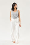 Ivory Bamboo Wide Leg Patch Pocket Pant modeled by a woman. The photo was taken in a high contrast setting, showing off the colors and lines of the pajamas. |Color: Ivory