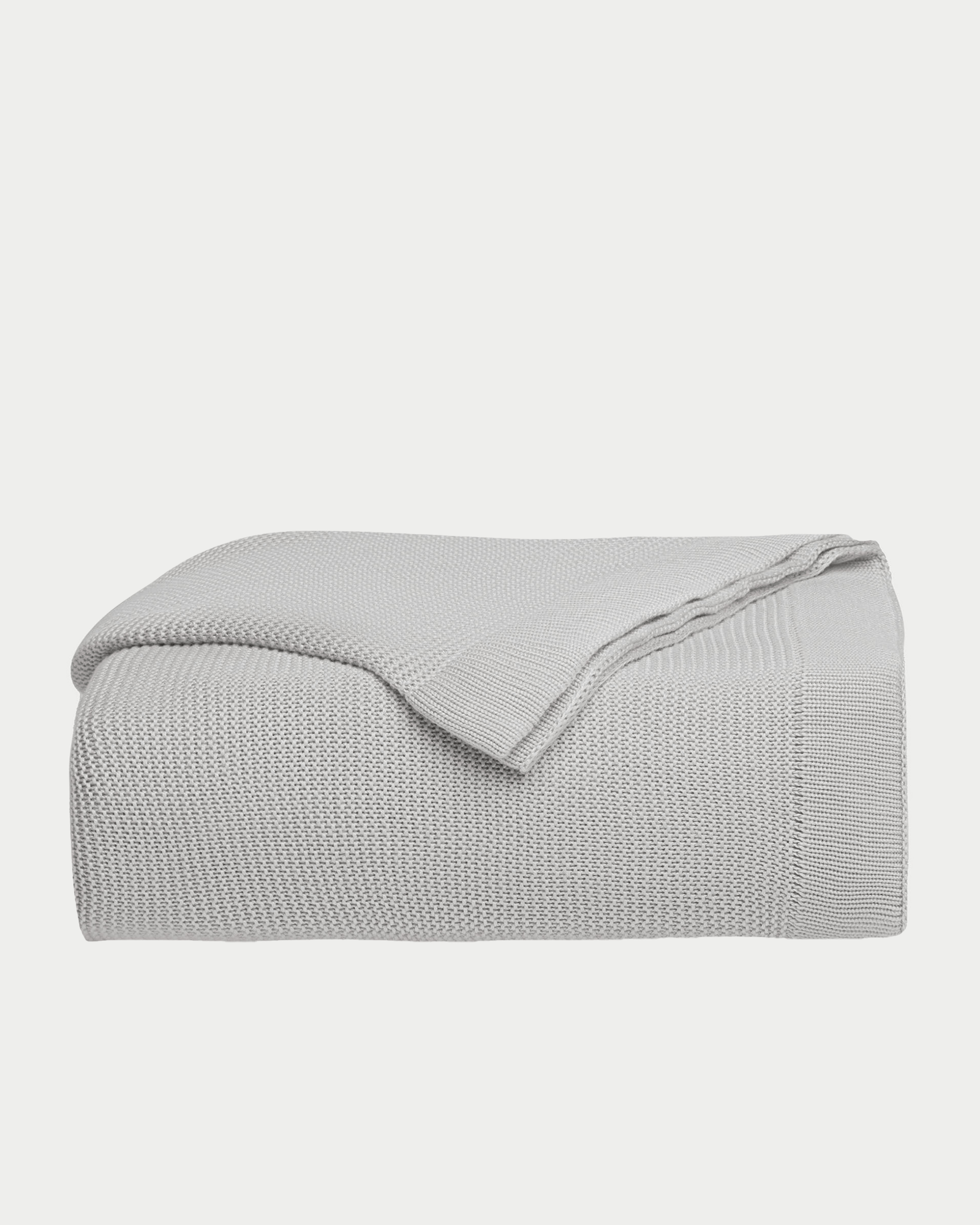 Light Grey cloud knit blanket folded with white background 