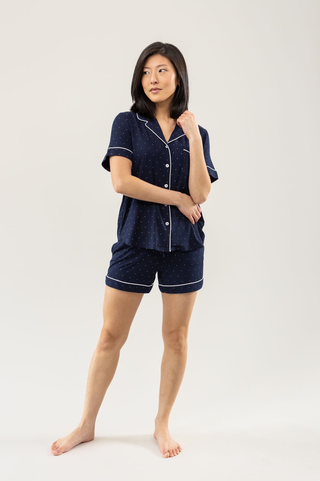 Mini Dot Short Sleeve Pajama Set modeled by a women. The photo was taken in a light setting; showing off the pajamas. |Color:Mini Dot