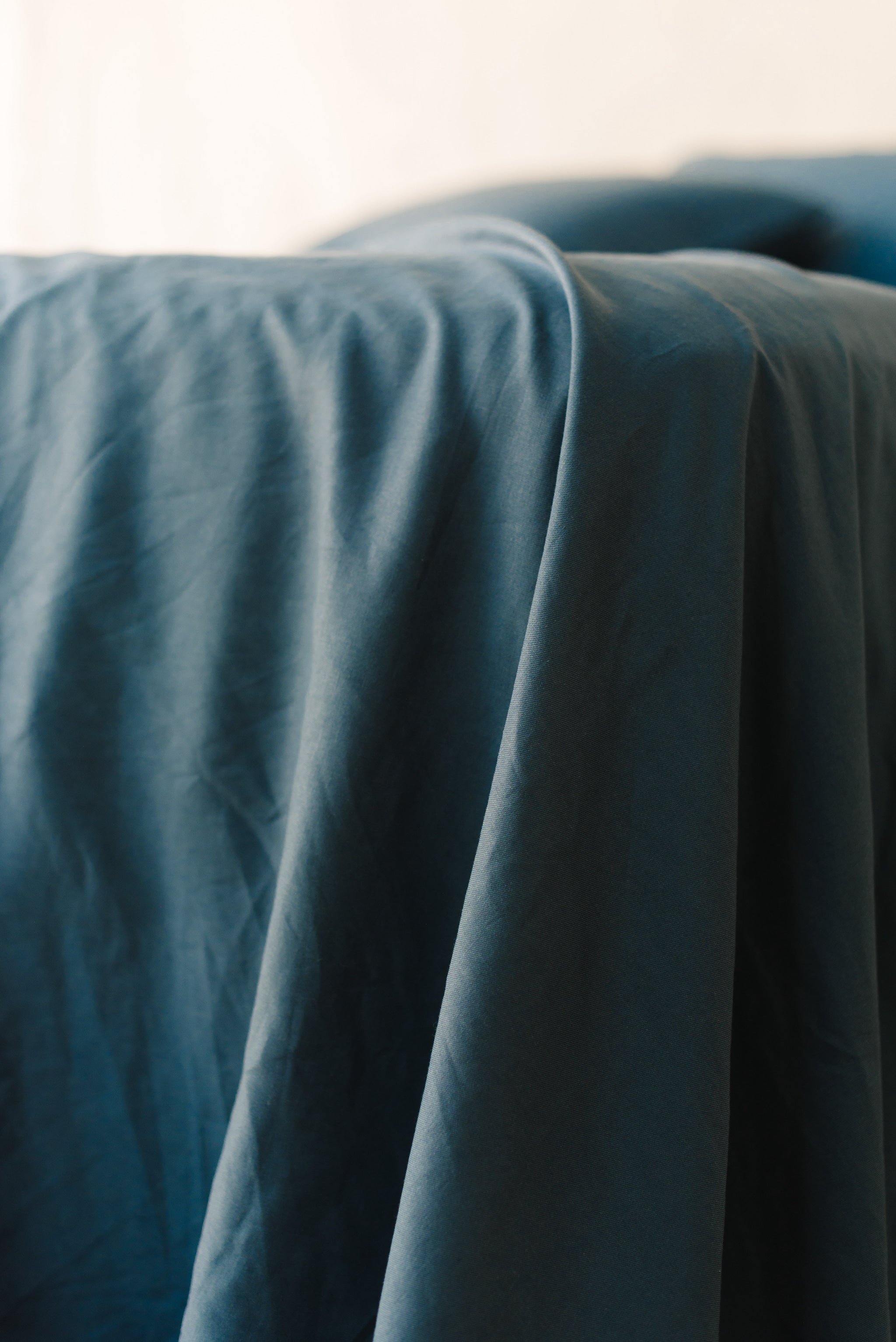 Navy Linen Bamboo Fitted Sheet on bed. 