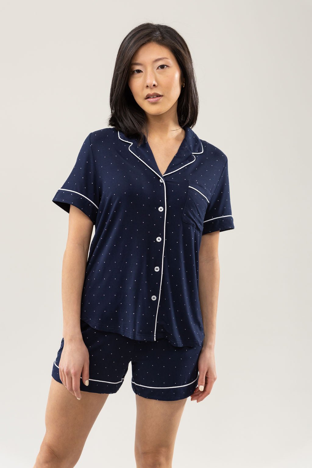 Mini Dot Short Sleeve Pajama Set modeled by a women. The photo was taken in a light setting; showing off the pajamas. 