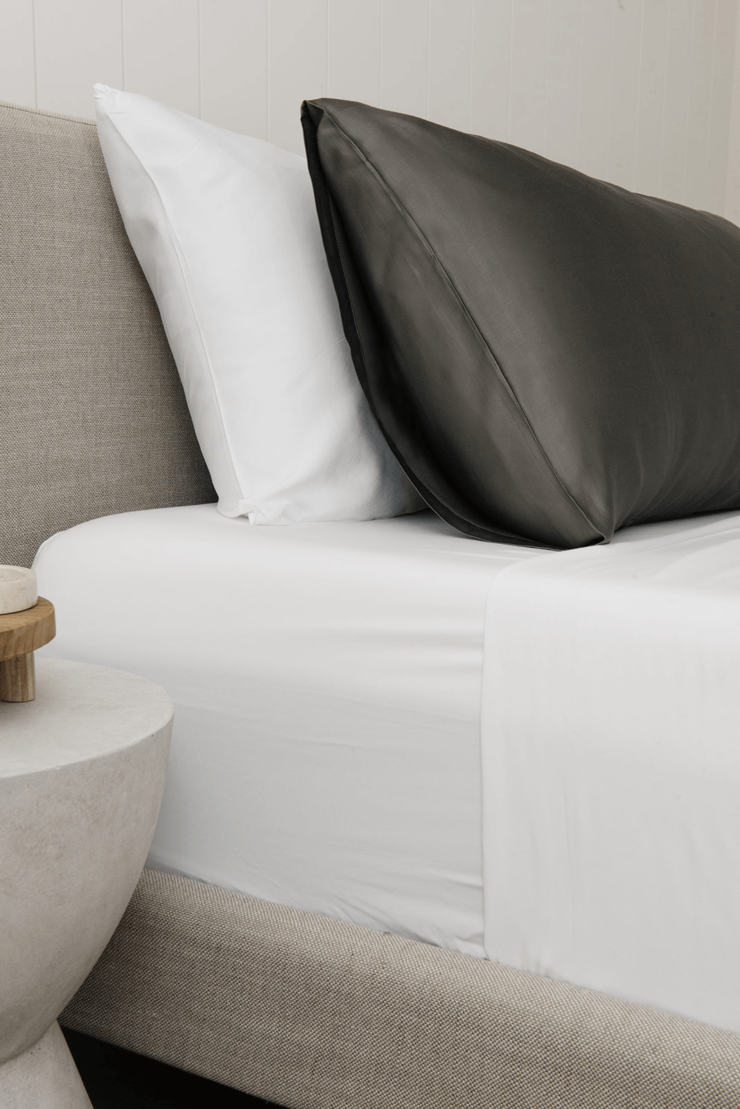 Charcoal standard/king pillowcase on bed with other pillow behind it 
