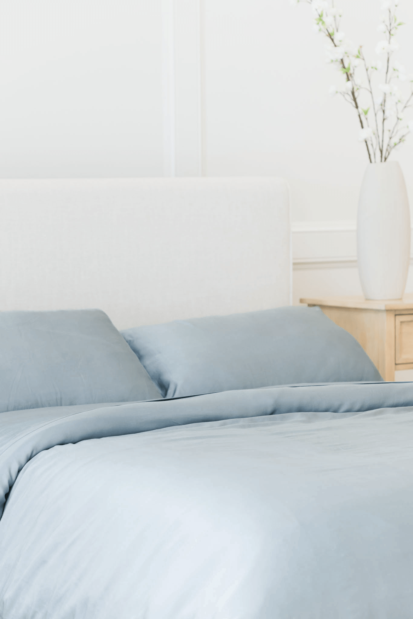 Bed with harbor mist bedding in a clean room 
