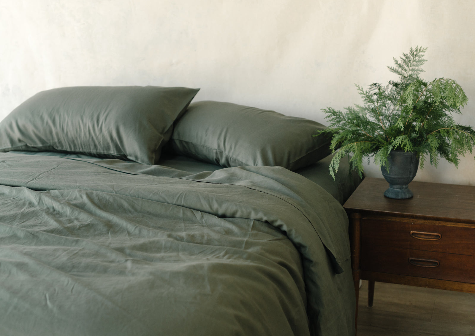 Olive Linen Bamboo Flat Sheet on bed. 