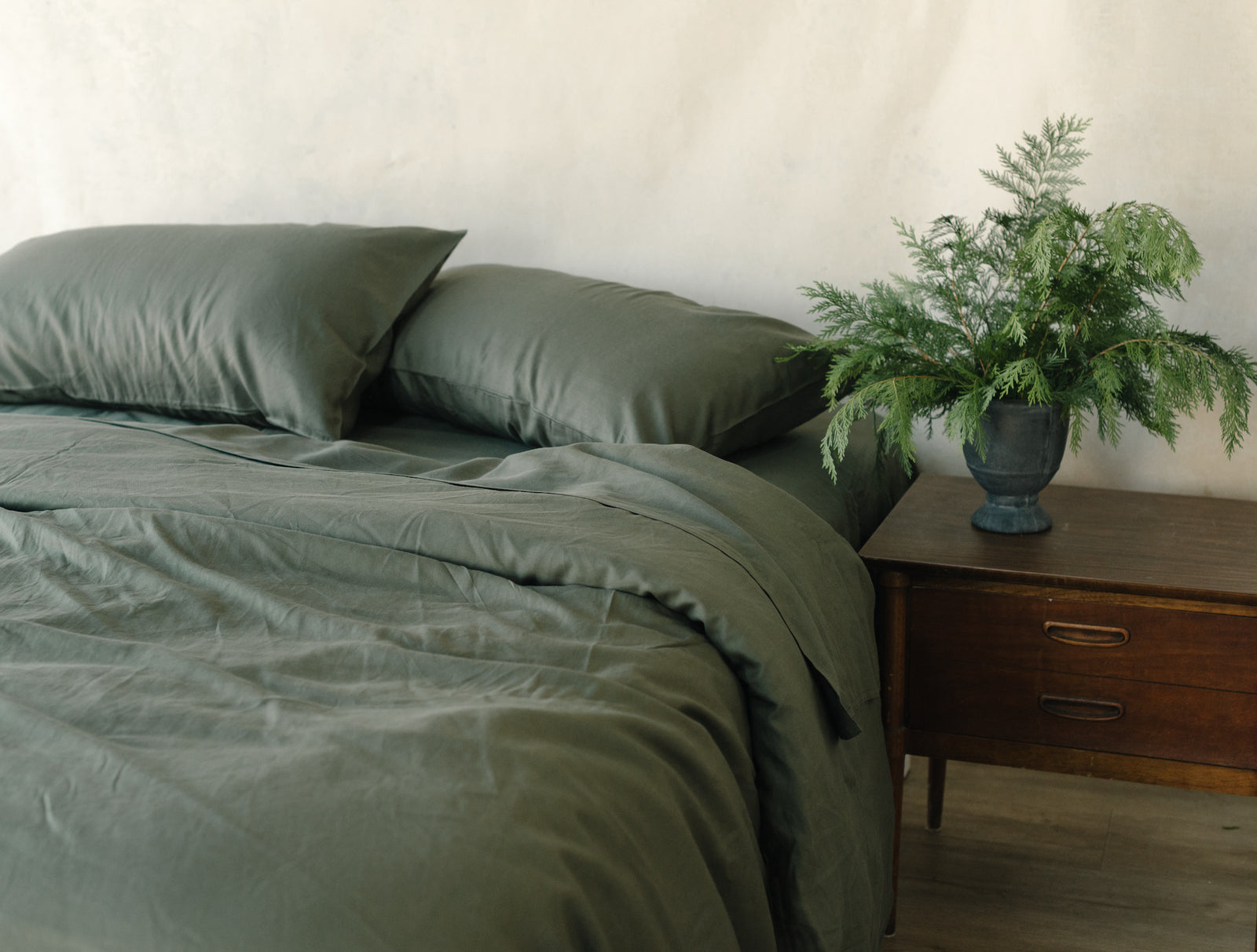 Olive Duvet Cover and comforter resting on a bed. 