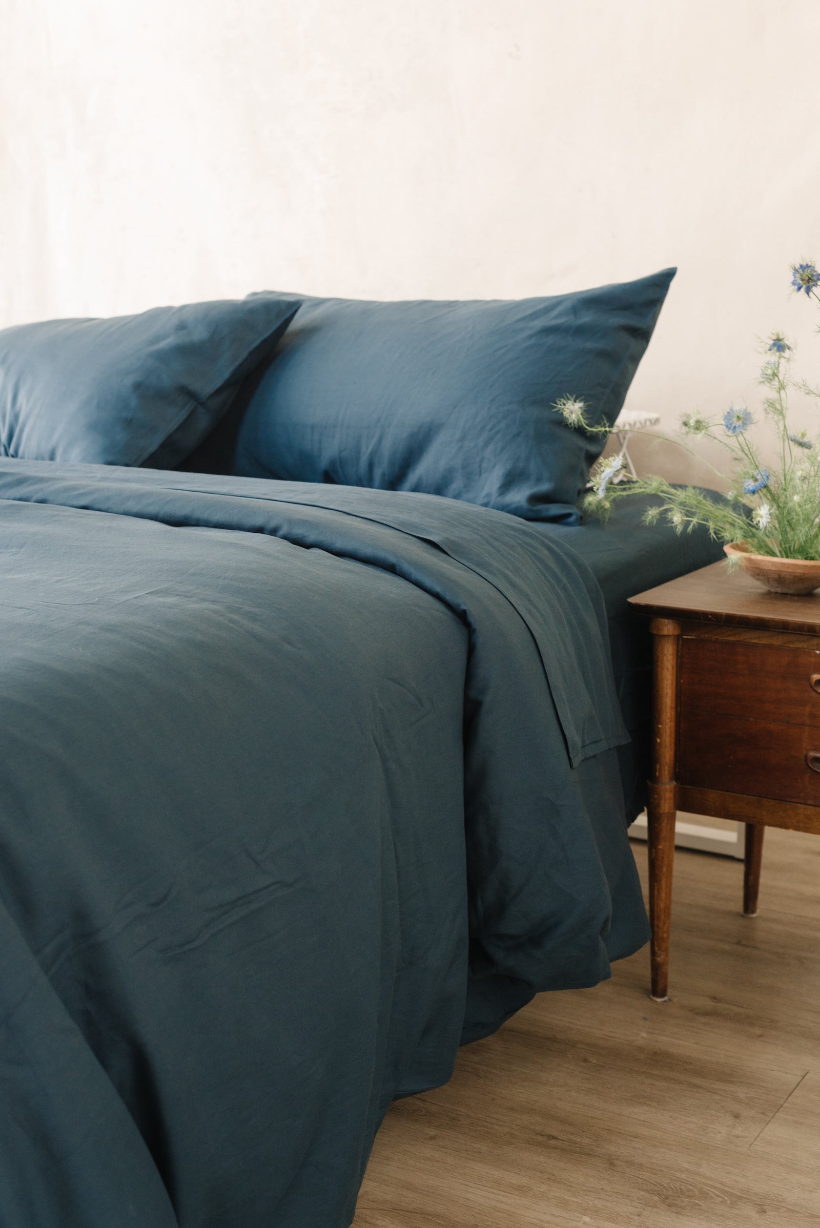 Navy Linen Bamboo Fitted Sheet on bed. 