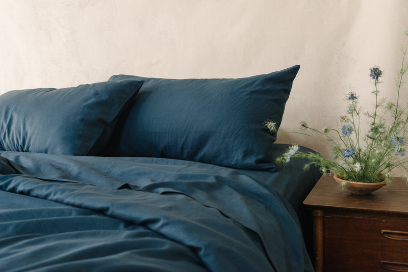 Navy Bamboo Linen Pillow Cases on a navy bed.