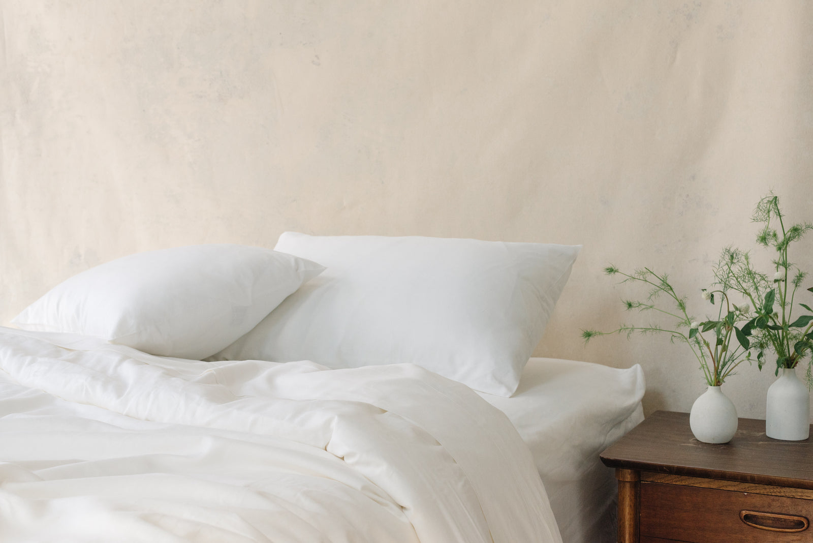White Bamboo Linen Pillow Cases on a navy bed. 