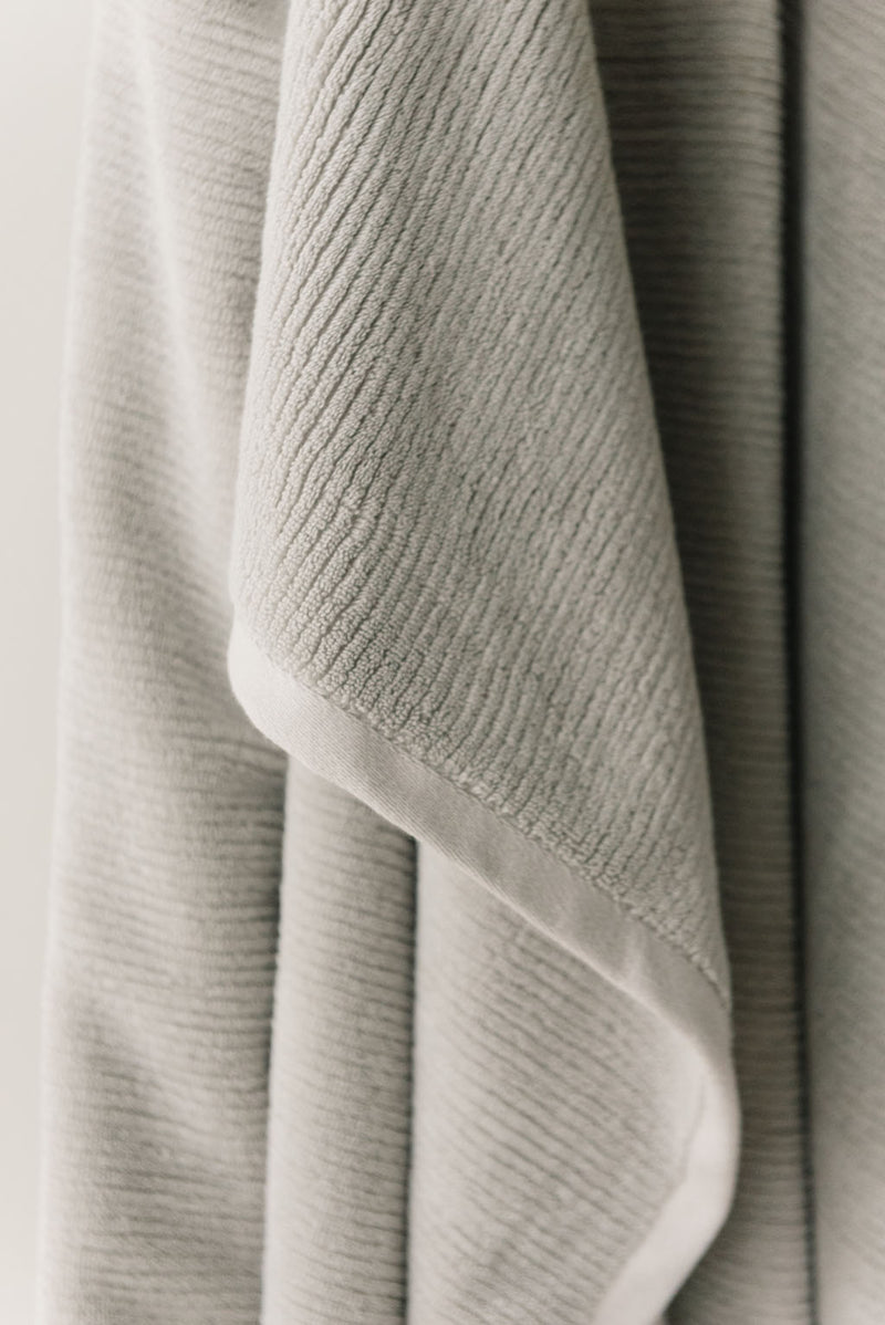Ribbed Terry Bath Sheets in the color Light Grey. Photo of the towel is taken close up.