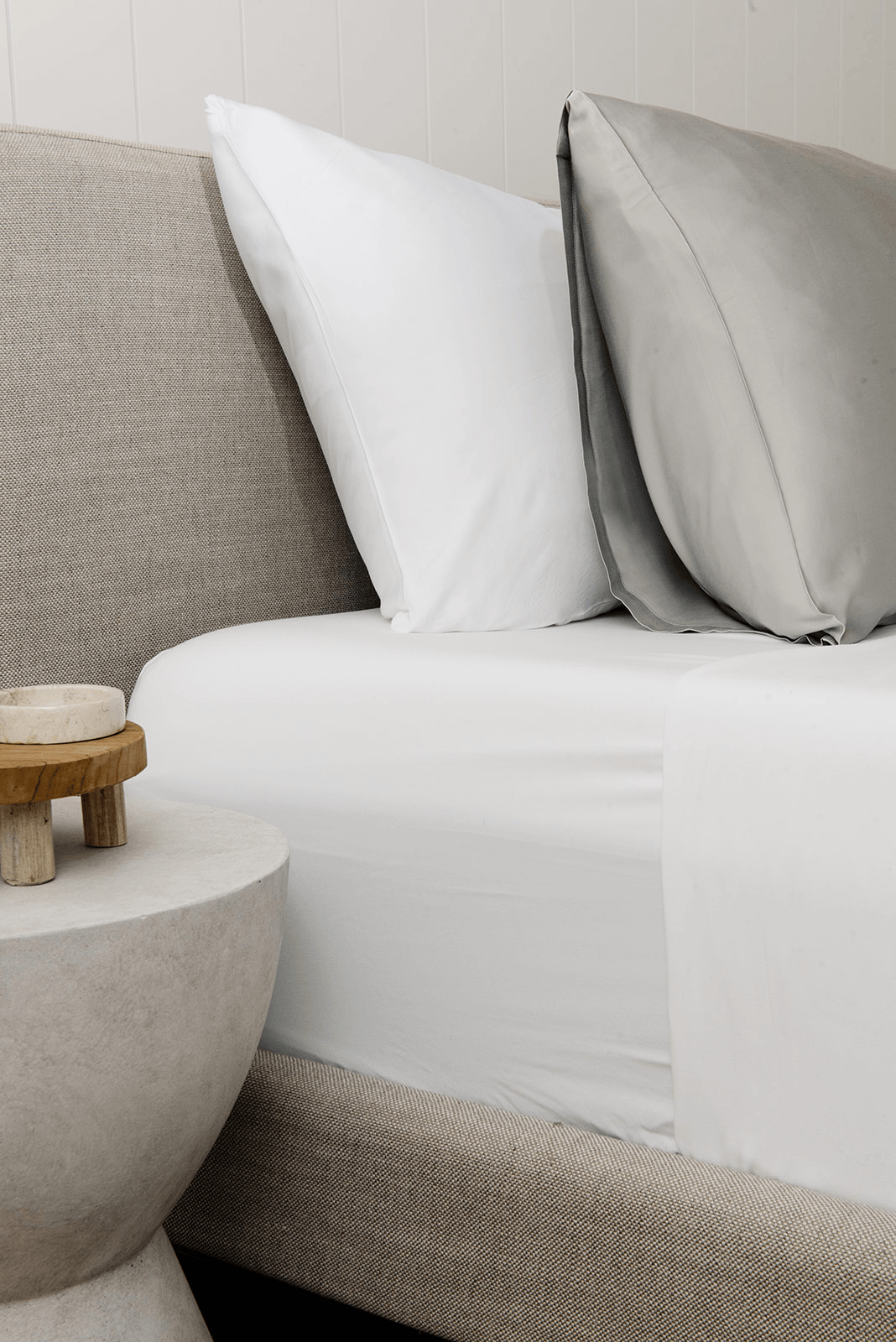 Light Grey standard/king pillowcase on bed with other pillow behind it 