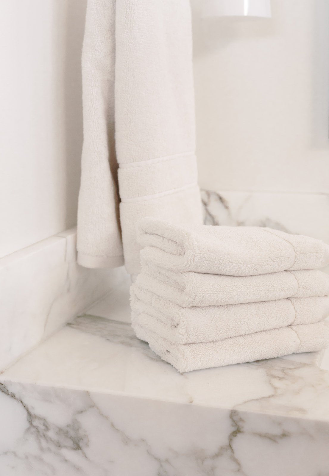 Seashell Premium Plush Wash Cloths. Photo of Premium Plush Wash Cloths taken with in a white bathroom with marble counter tops. 