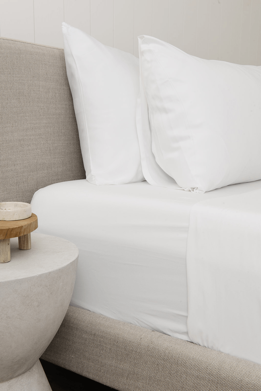 White standard/king pillowcase on bed with other pillow behind it 