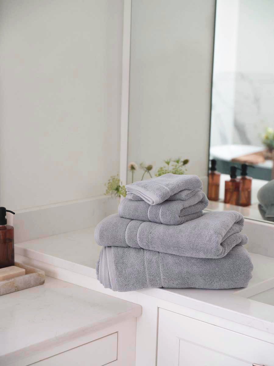 Premium Plush Bath towel/hand towel in the color Harbor Mist. Photo of Harbor Mist Premium Plush Bath towel/hand towel taken in a bathroom with white walls. 