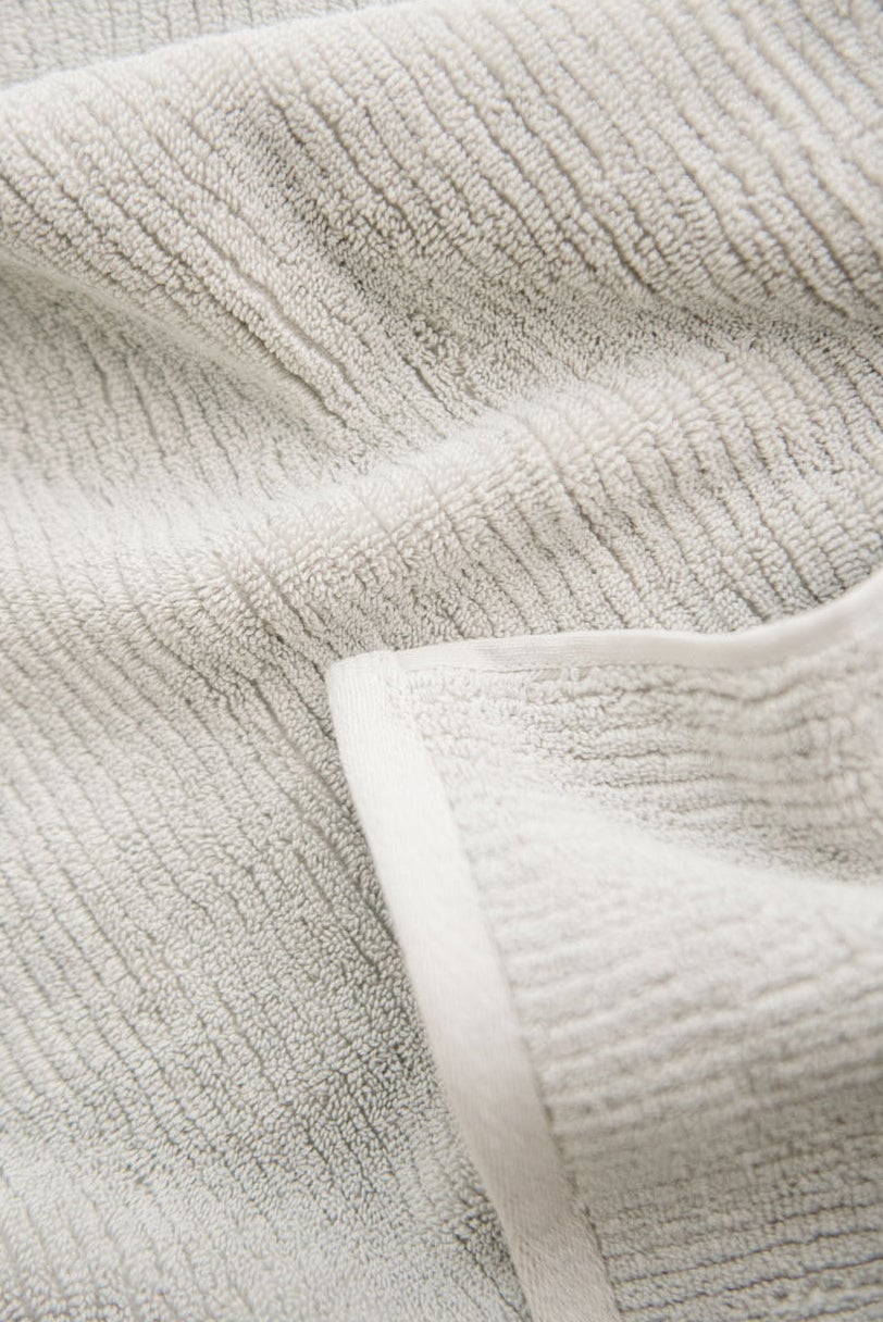 Ribbed Terry Hand Towels in the color Light Grey. Photo of product taken as a close up. 
