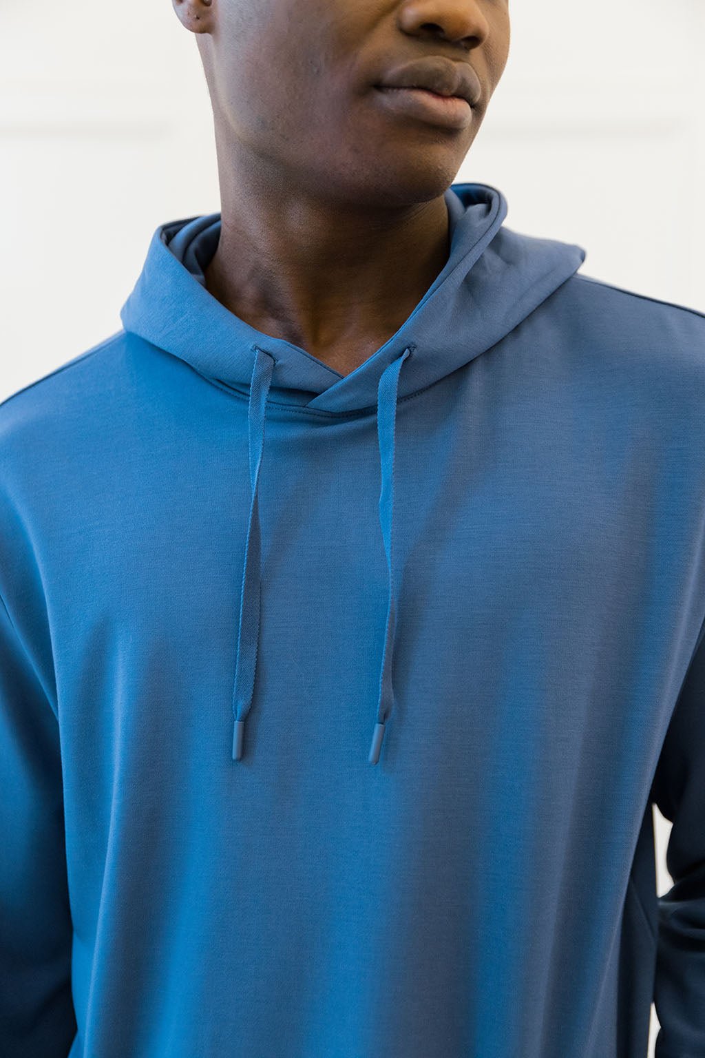 Cobalt Bamboo Hoodie worn by a man standing in front of white background.