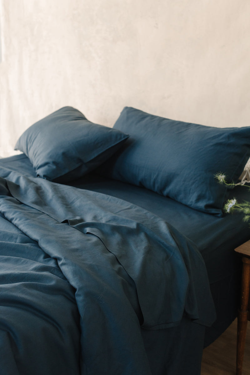 Navy Bamboo Linen Pillow Cases on a navy bed.