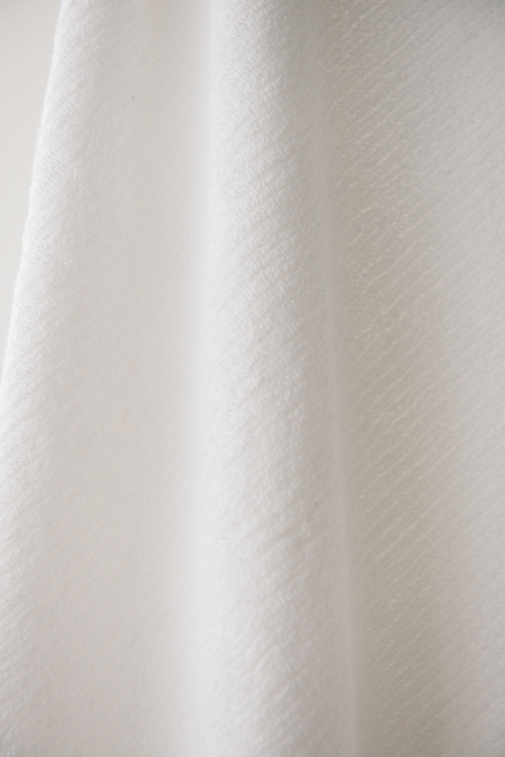 Ribbed Terry Bath Sheets in the color White. Photo of the towel is taken close up. 