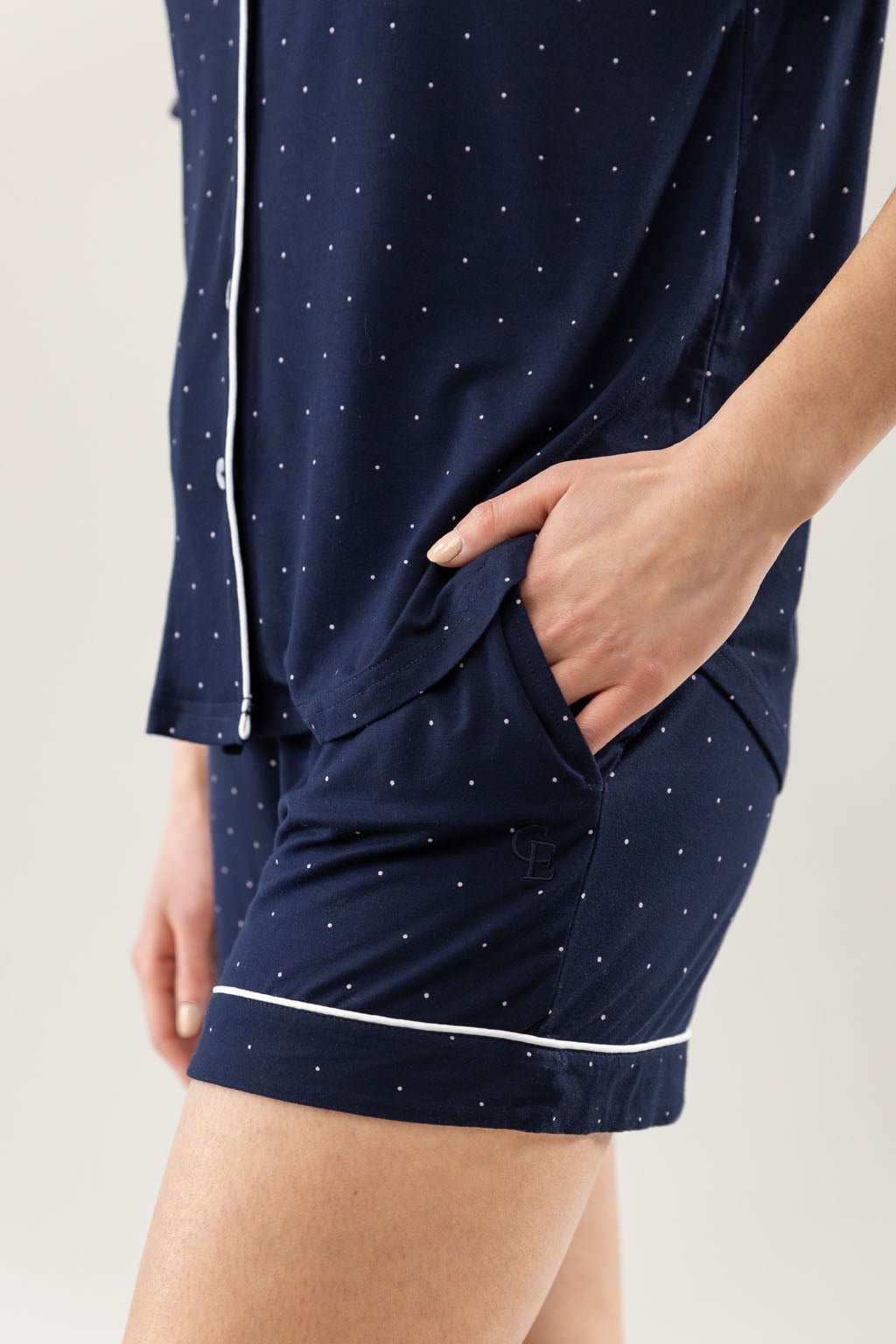 Mini Dot Short Sleeve Pajama Set modeled by a women. The photo was taken in a light setting; showing off the pajamas. 