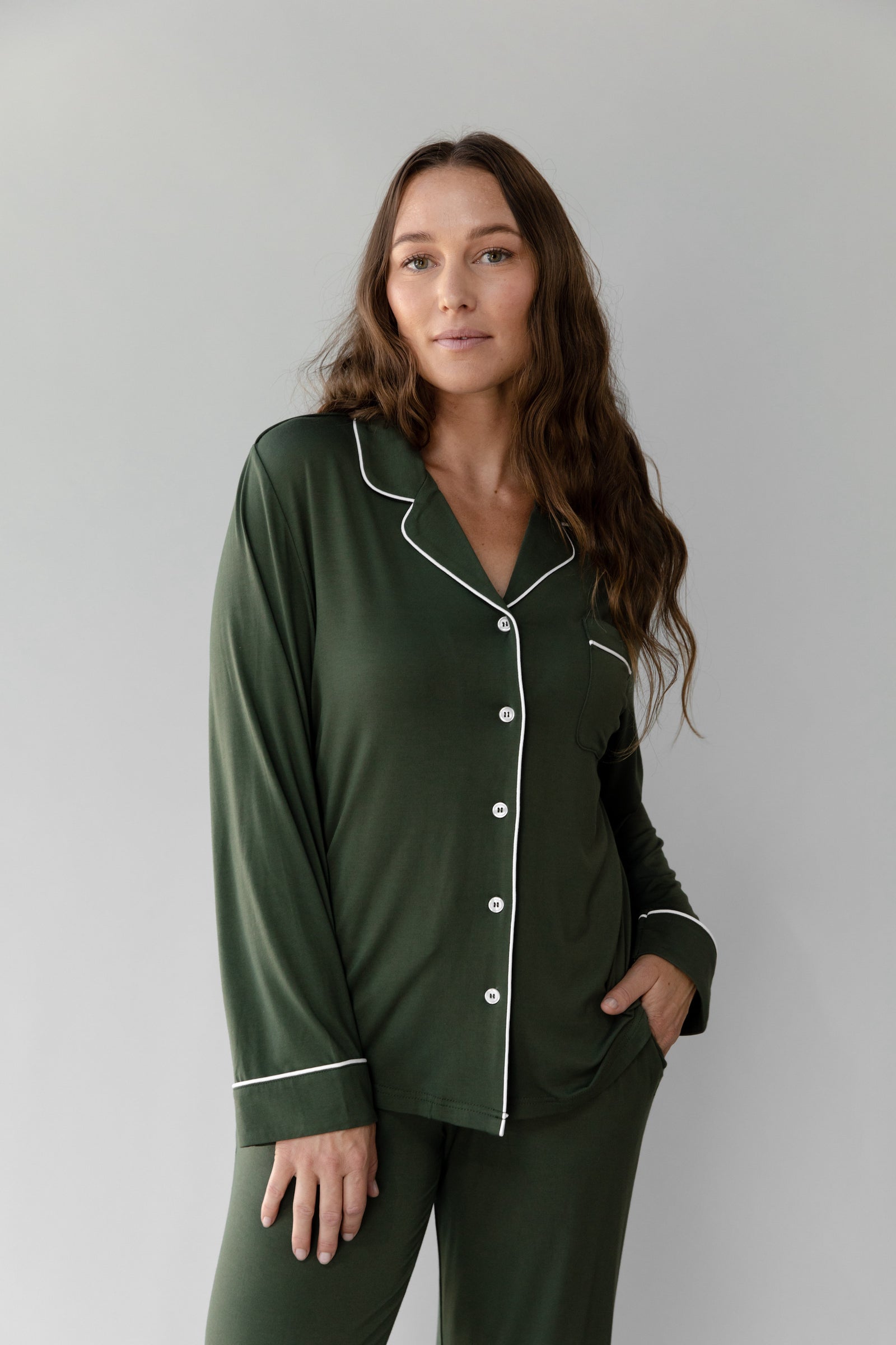 Olive Long Sleeve Pajama Set modeled by a woman. The photo was taken in a high contrast setting, showing off the colors and lines of the pajamas. 