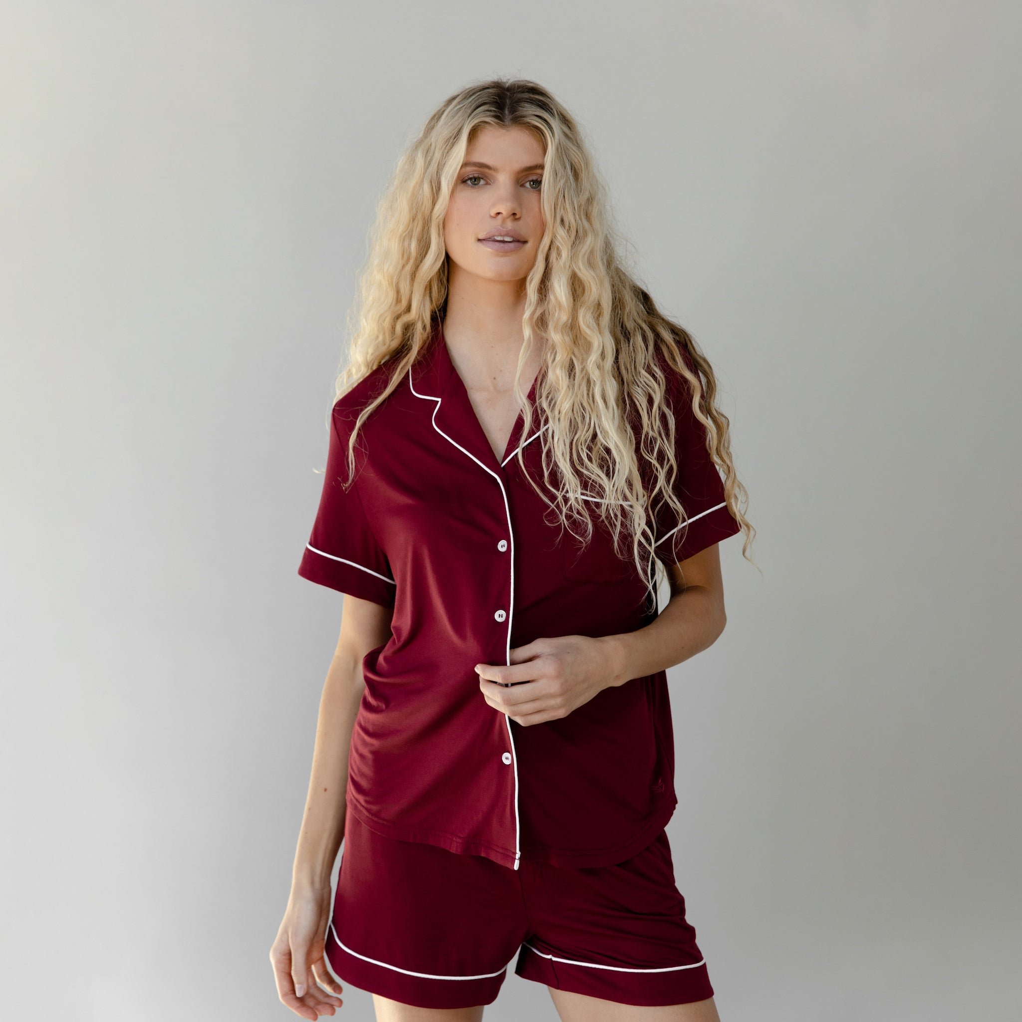 Pomegranate Short Sleeve Pajama Set modeled by a women. The photo was taken in a light setting; showing off the pajamas. 