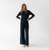 Navy Bamboo Wide Leg Patch Pocket Pant modeled by a woman. The photo was taken in a high contrast setting, showing off the colors and lines of the pajamas. |Color: Navy