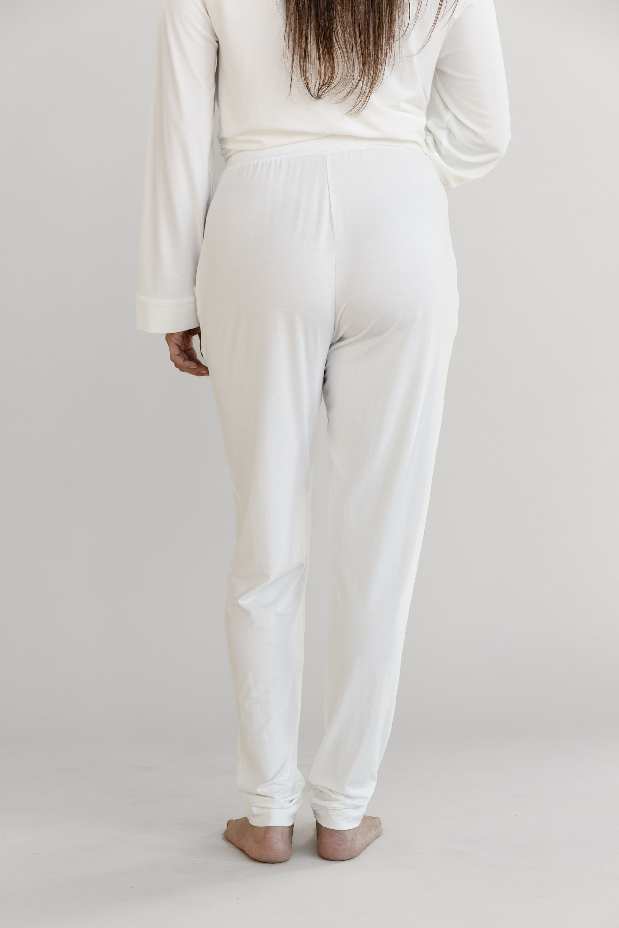 Gray Cozy Earth Stretch Knit Tapered Pant set worn by a person on a light gray background. They face backwards 