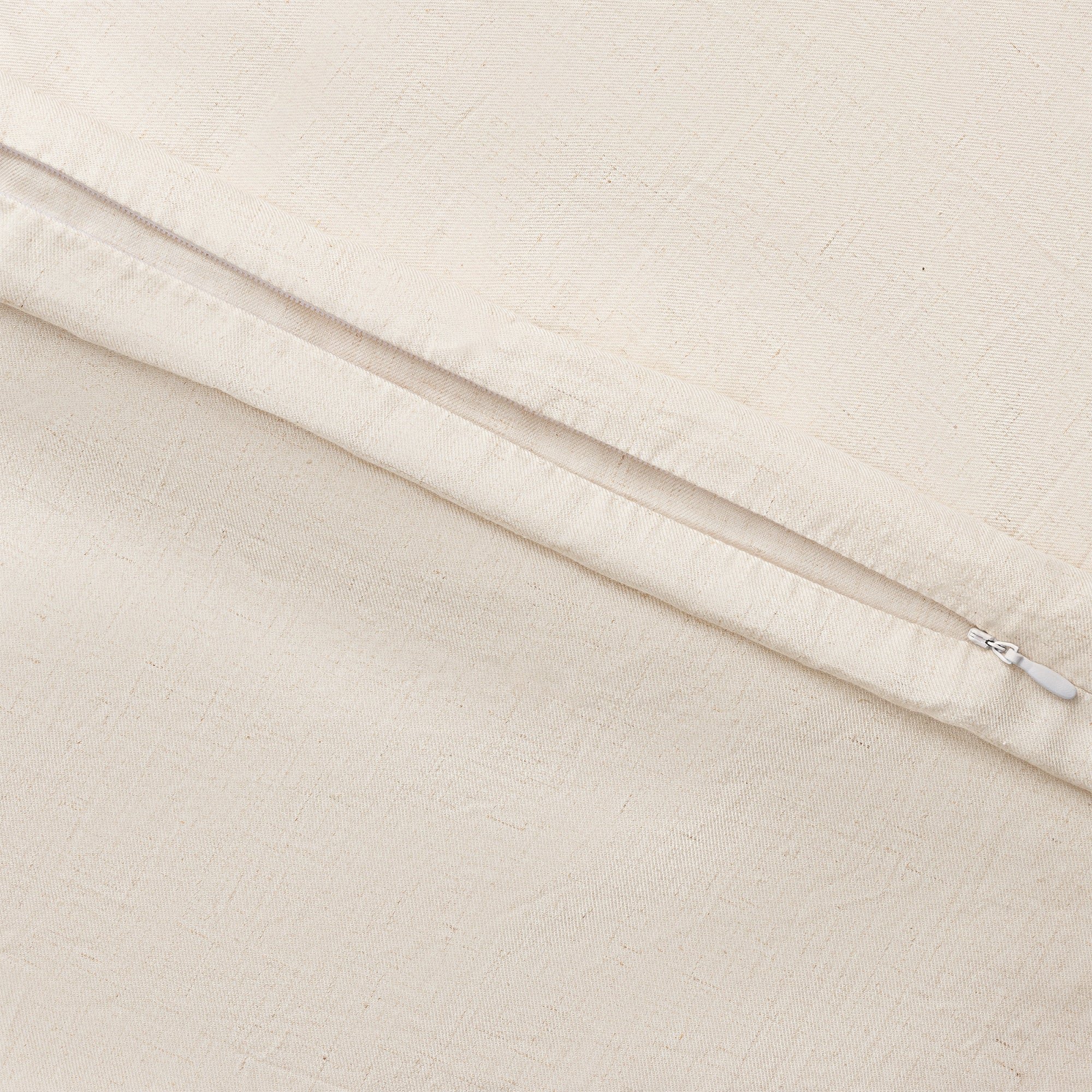 Natural Linen Bamboo Duvet Cover and comforter resting on a bed. Photo or product taken close up. 