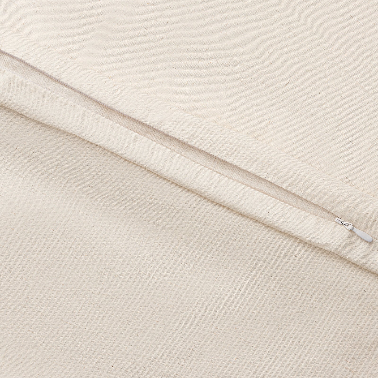 Natural Linen Bamboo Duvet Cover and comforter resting on a bed. Photo or product taken close up. 
