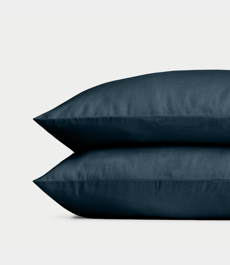 Navy Linen Bamboo Pillow Shams photographed over a white background.