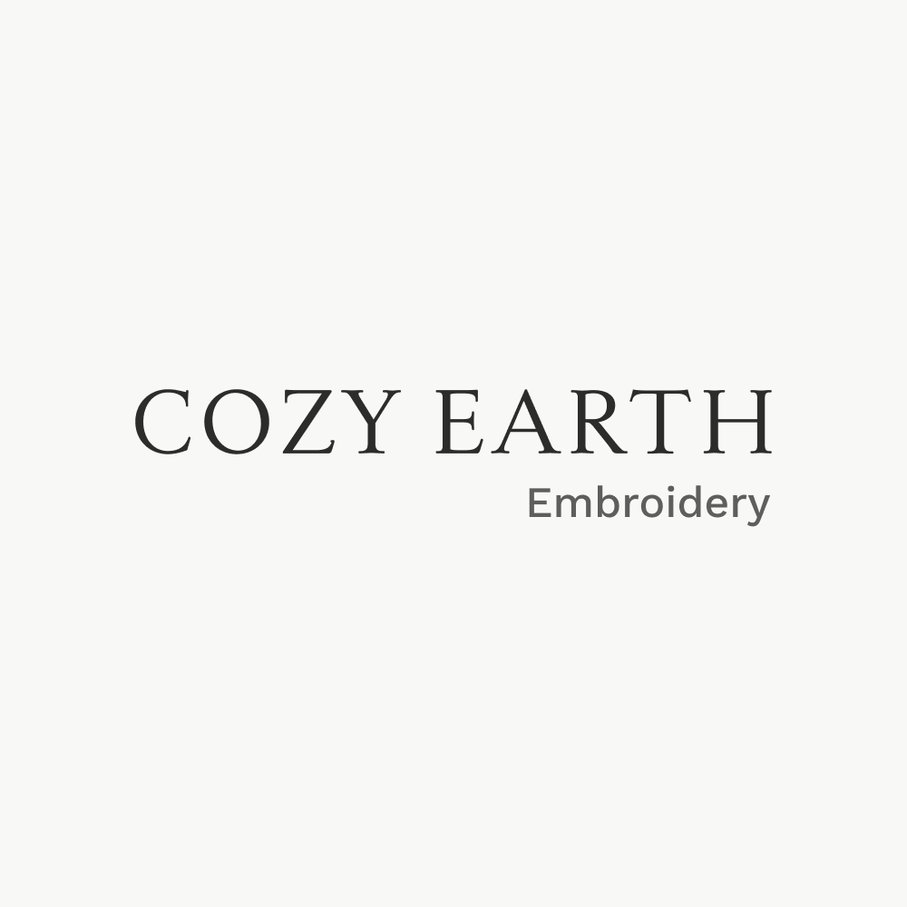 The image displays "COZY EARTH" in bold capital letters above "Embroidery" in a smaller font, set against a plain white background.