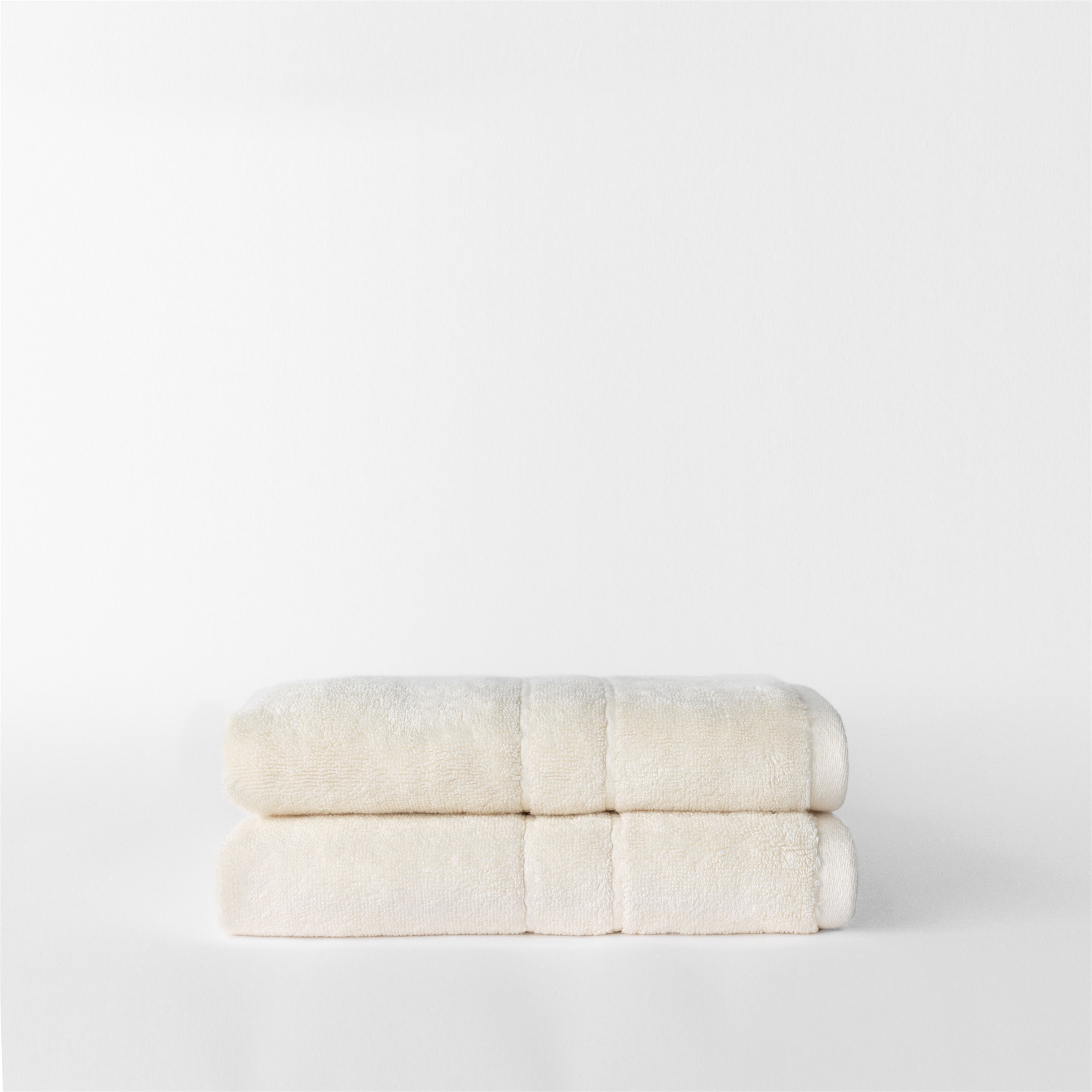 Premium Plush Hand Towels in the color creme. Photo of Complete Premium Plush Hand Towel taken with white background 